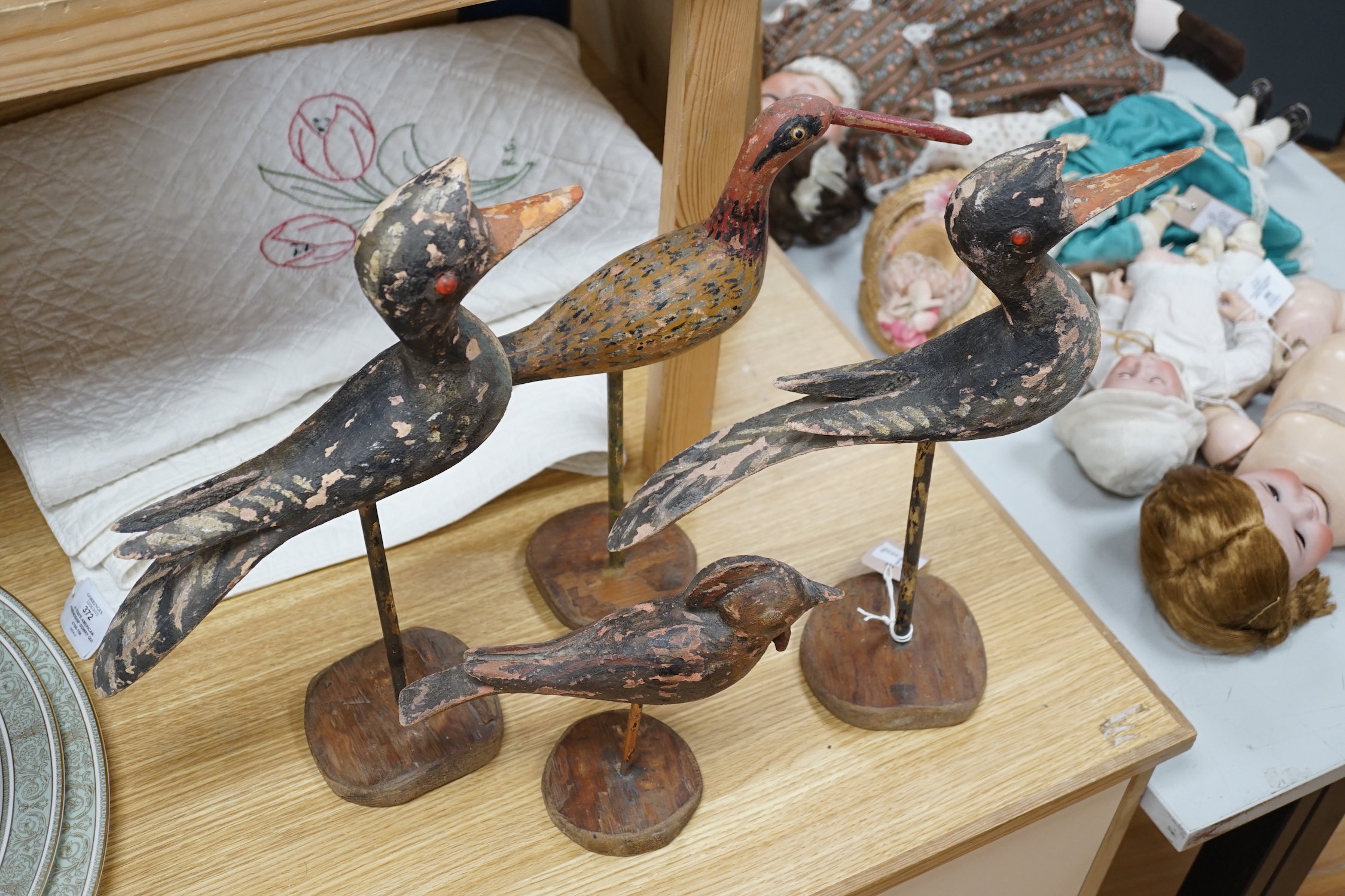 Four various wooden folk art wild birds. Tallest 43cm